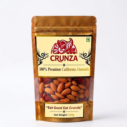 A 100g stand-up pouch of CRUNZA 100% Premium California Almonds on a clean white background. The packaging is metallic gold with a cream-colored label featuring the red CRUNZA logo.