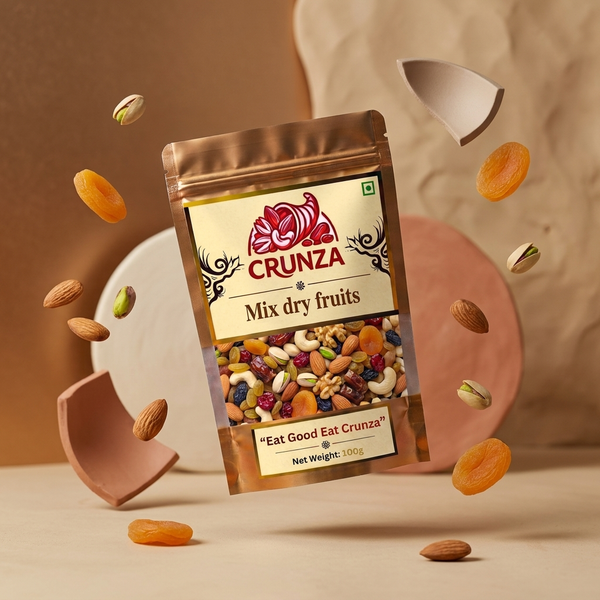 A stand-up pouch of CRUNZA Mix dry fruits floating in mid-air, surrounded by scattered almonds, dried apricots, pistachios, and broken ceramic pieces against a warm beige and brown textured background.