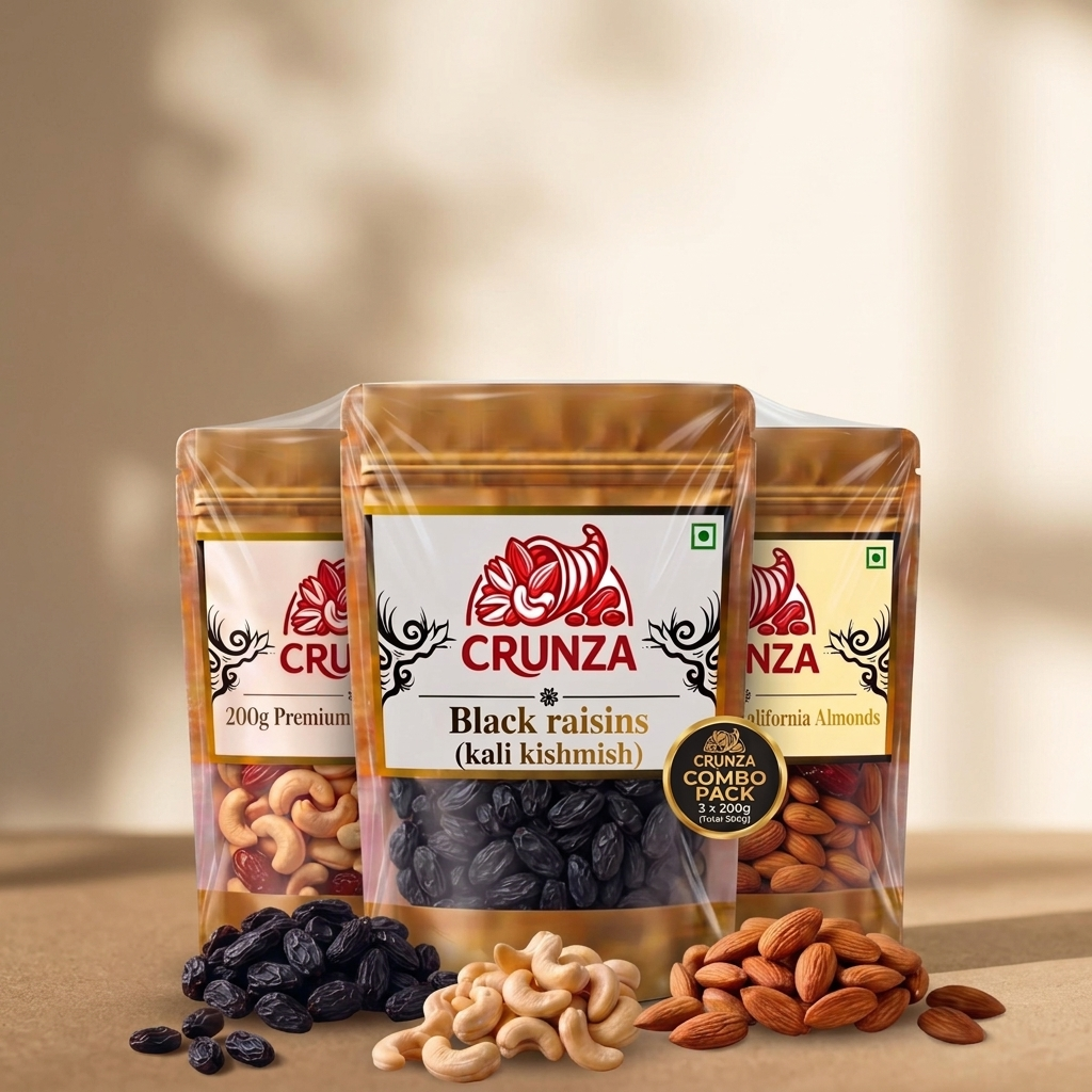 Three stand-up pouches of CRUNZA nuts and dried fruits arranged together on a beige surface with loose almonds, cashews, and black raisins in front. The center pouch is labeled Black raisins (kali kishmish), with additional labels showing California Almonds and Premium Cashews behind it.